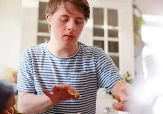 depositphotos_299179314-stock-photo-young-downs-syndrome-man-baking